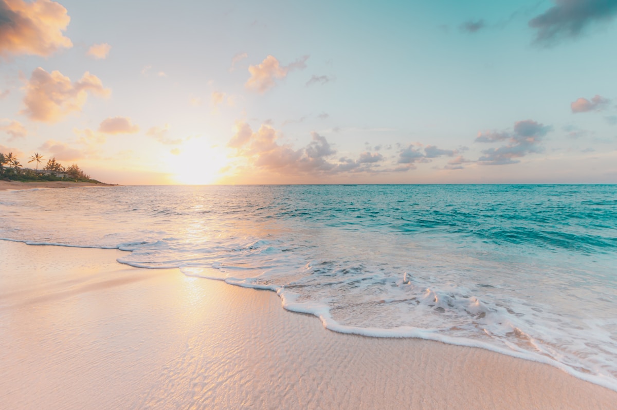 Tropical beach sunset with turquoise water and white sand