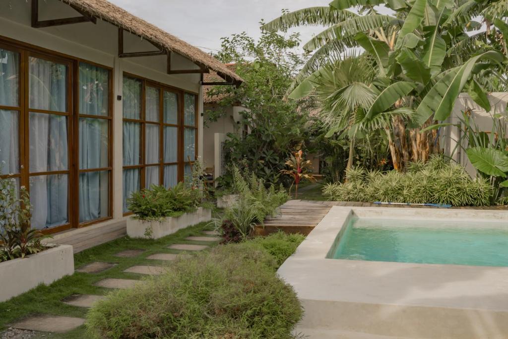 Single Fin building exterior with pool and lush tropical garden pathway